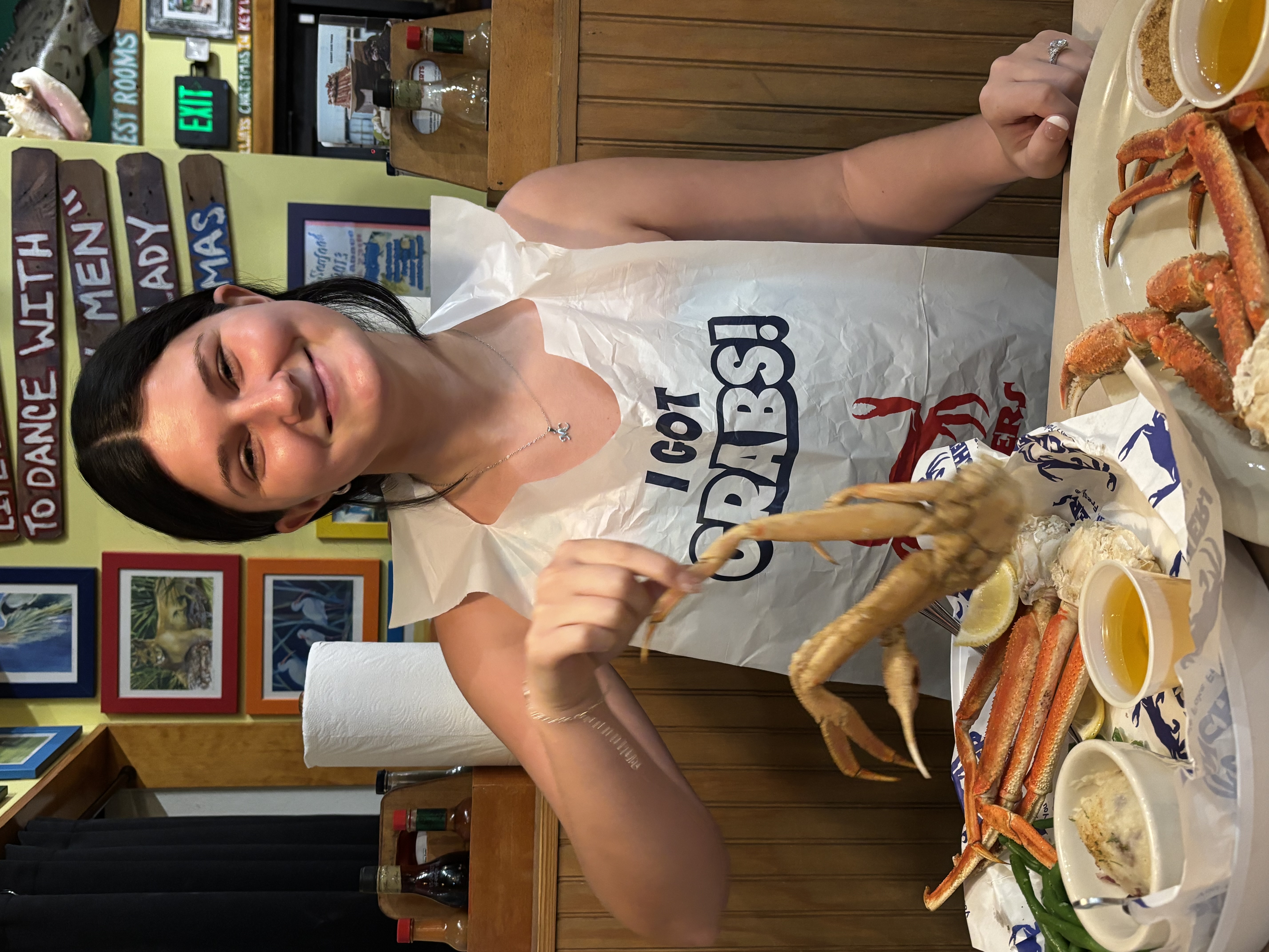 My wife smiling with a seafood meal during our honeymoon