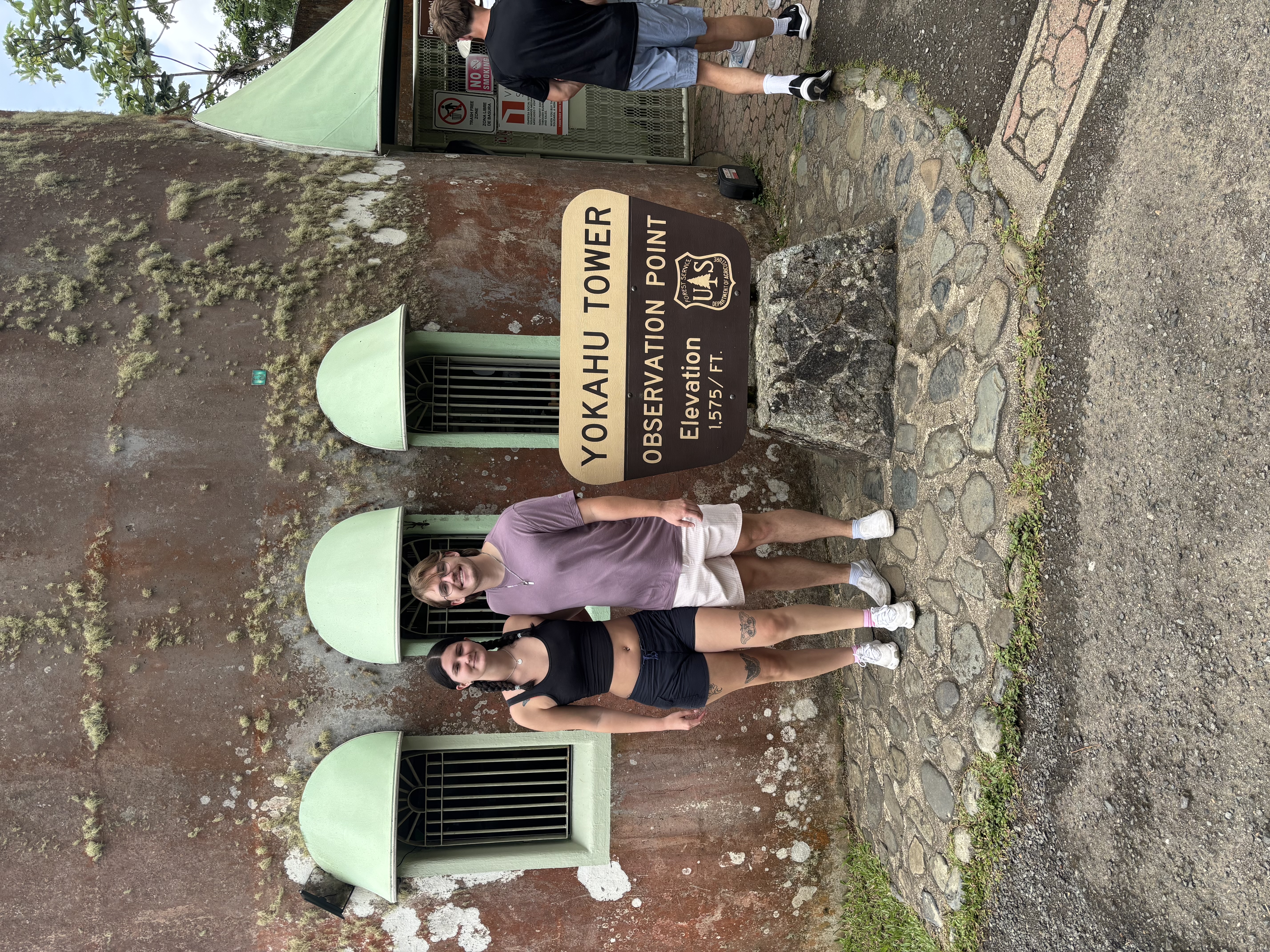 My wife and me beside the Yokahu Tower observation point sign